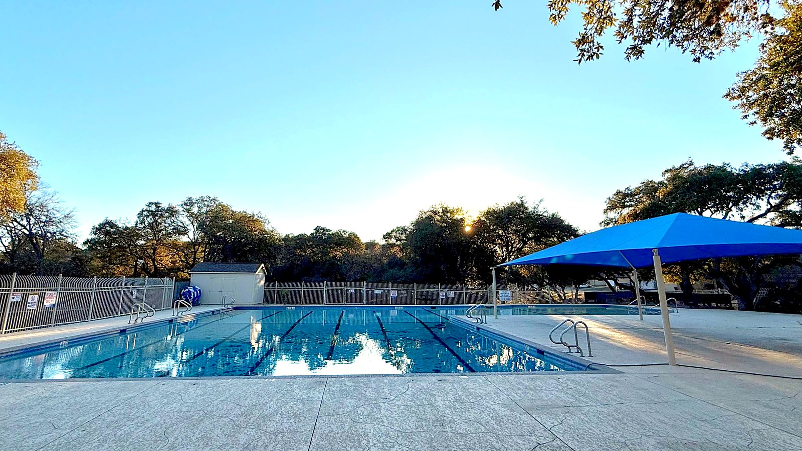 Parkwood community pool with lap lanes and blue shade canopy in San Antonio